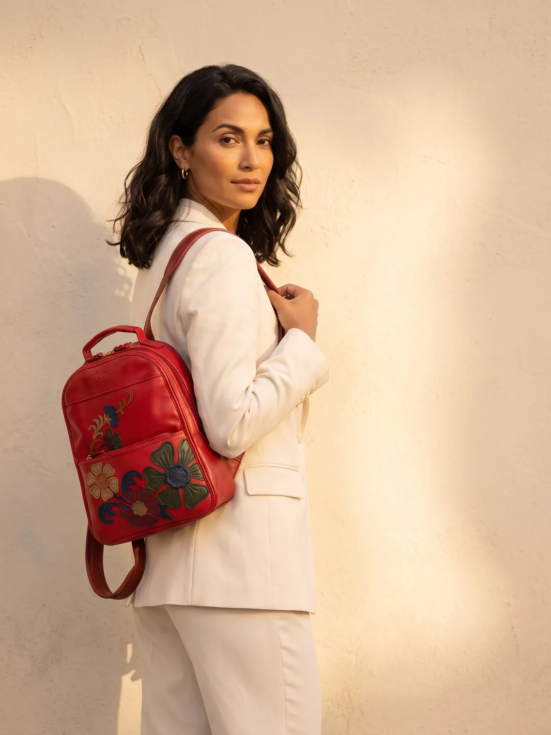 GÖN Handmade Flower Appliqué Backpack worn — carried in Red, from the campaign