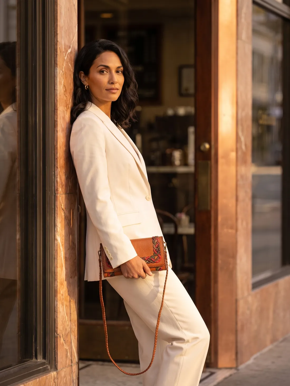 GÖN Handmade Sona Clutch worn — carried in Tan, from the campaign