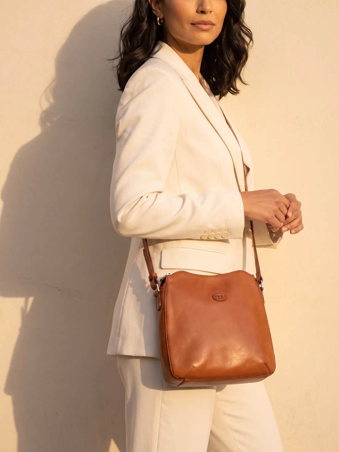 GÖN Handmade Ivme Crossbody Bag worn — carried in Tan, from the campaign