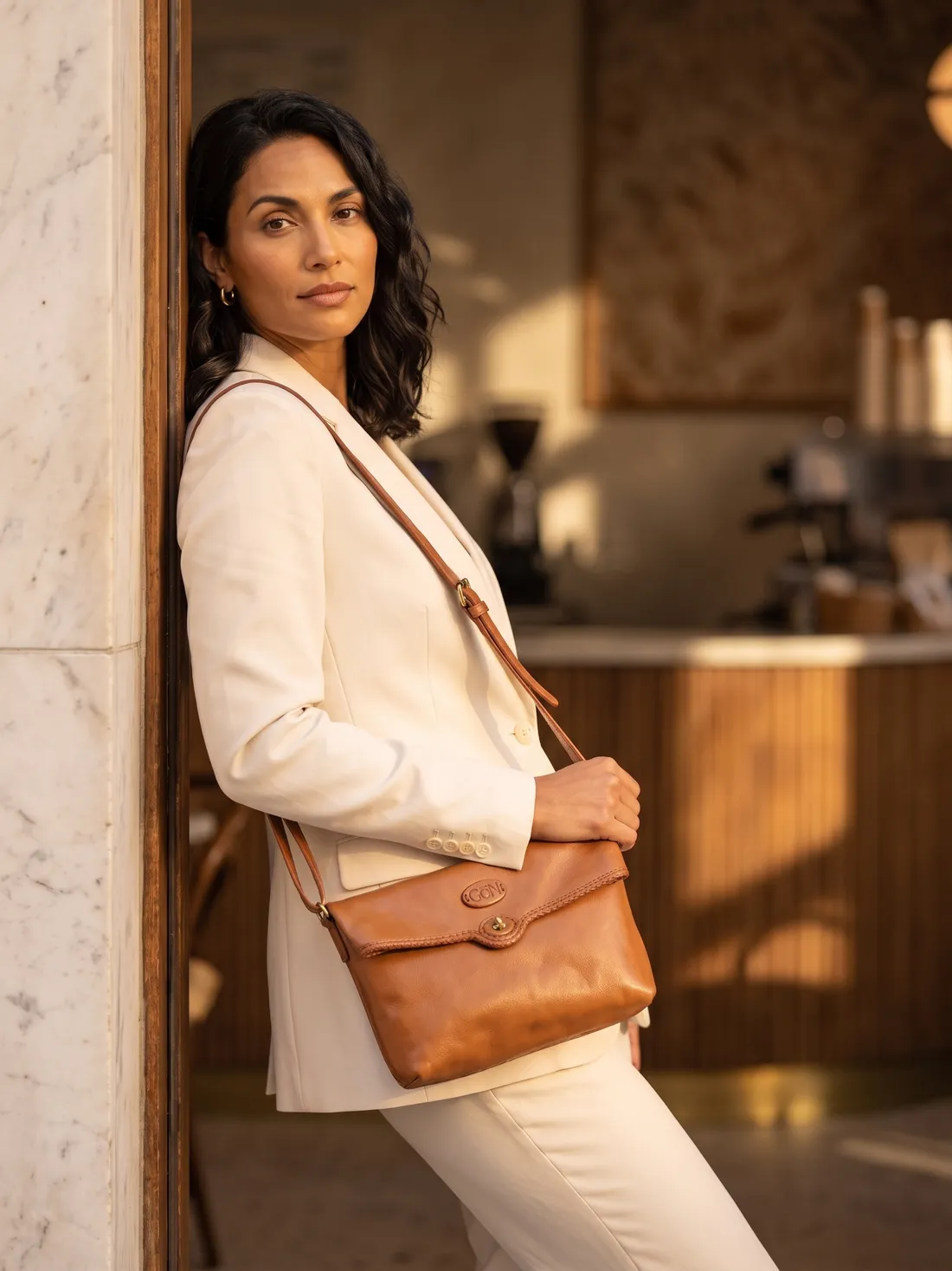 GÖN Handmade Tata Crossbody Bag worn — carried in Tan, from the campaign