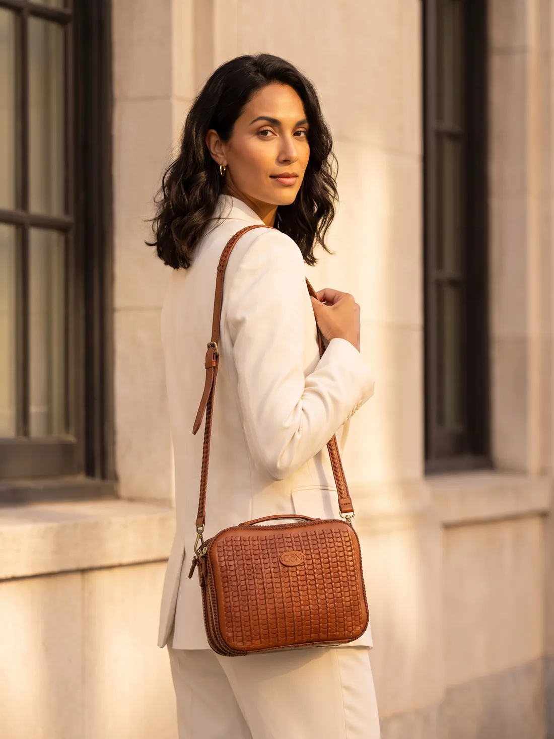 GÖN Handmade Tom Crossbody Bag worn — carried in Tan, from the campaign