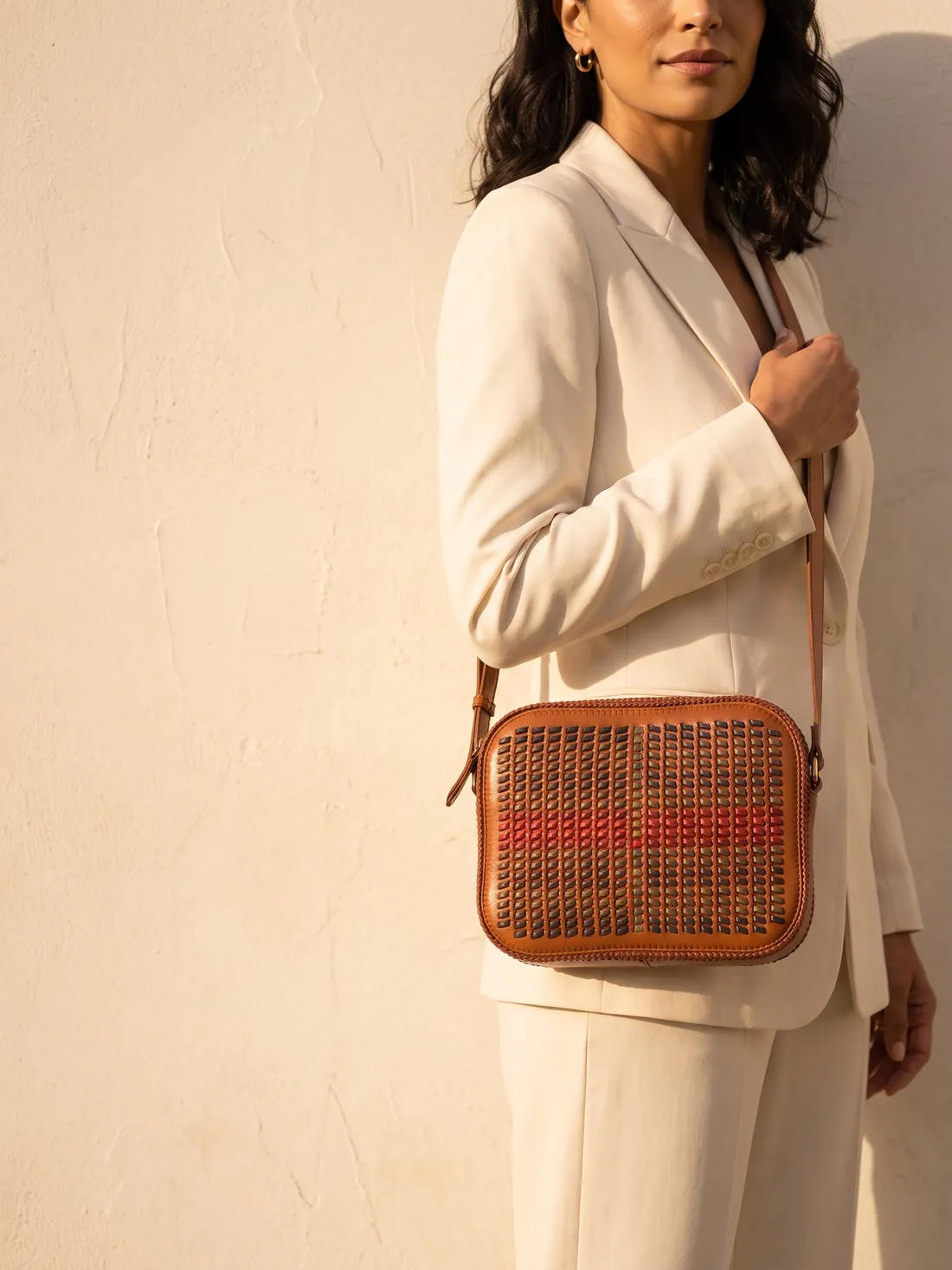 GÖN Handmade Checkweave Camera Bag worn — carried in Tan Multi, from the campaign
