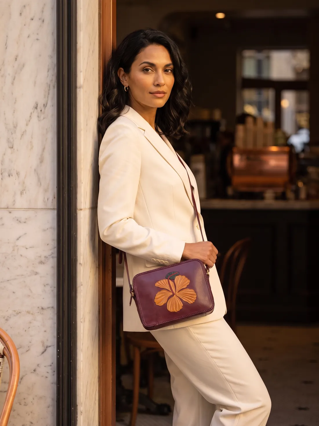 GÖN Handmade Flower Appliqué Crossbody worn — carried in Plum, from the campaign