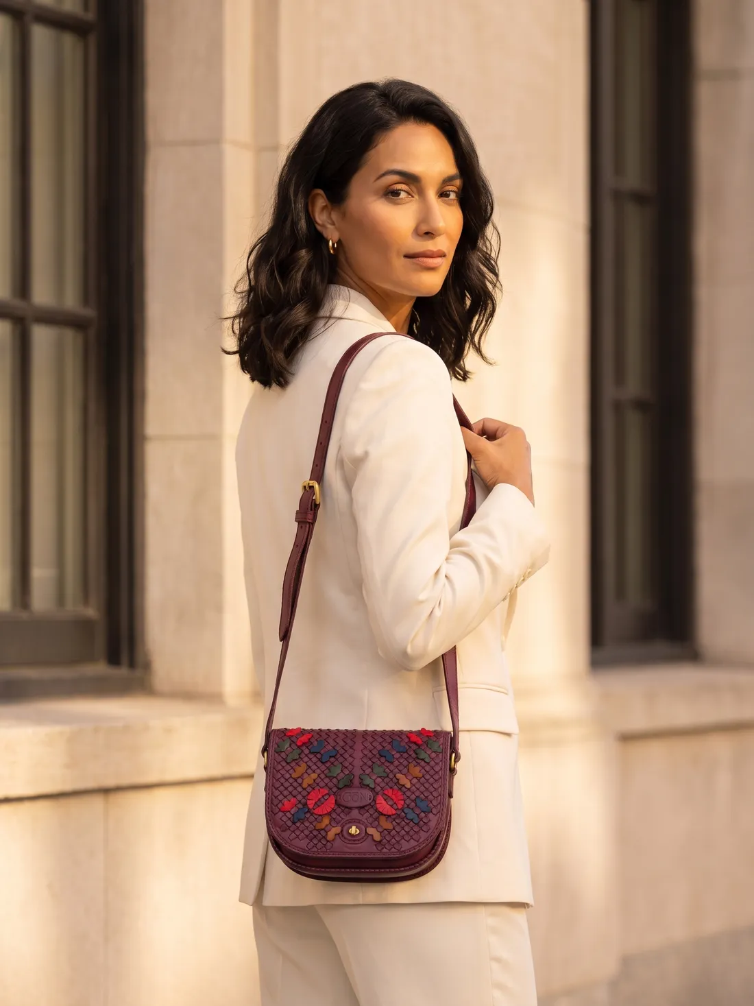 GÖN Handmade Saddle Flap Crossbody worn — carried in Plum Multi, from the campaign