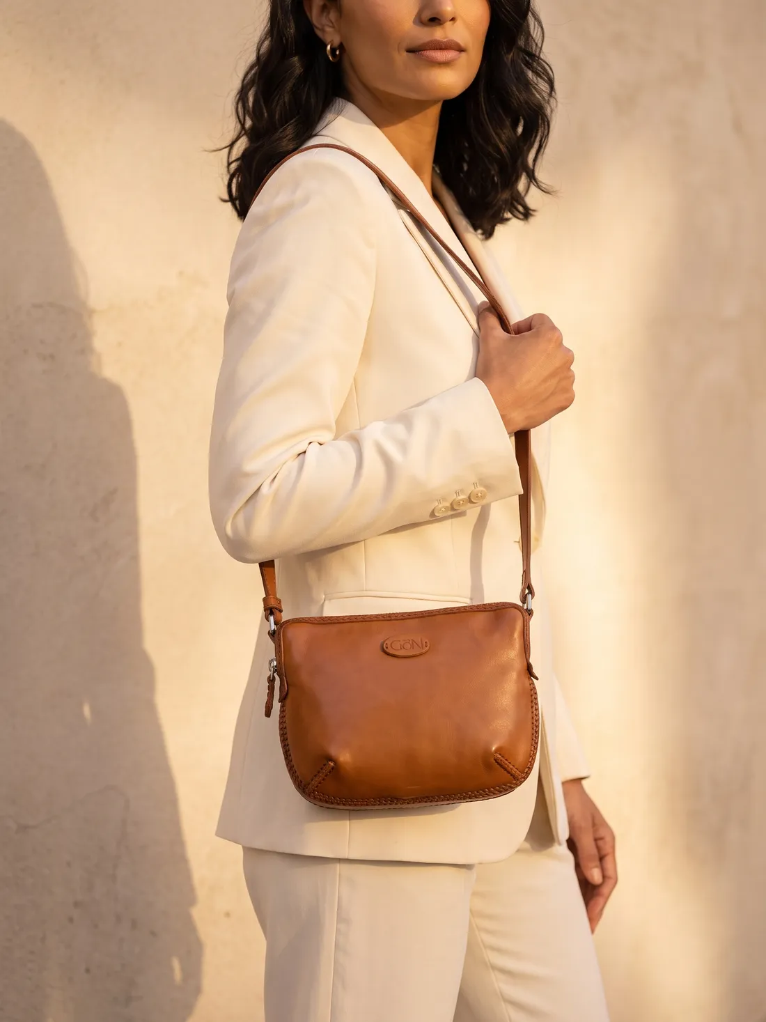 GÖN Handmade Dome Crossbody worn — carried in Tan, from the campaign