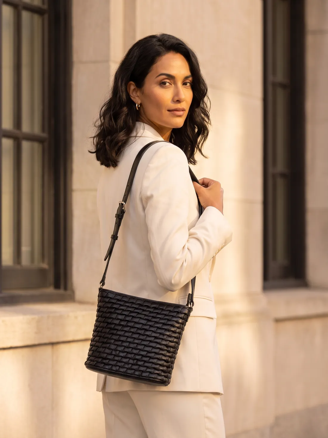 GÖN Handmade Woven Bucket Crossbody worn — carried in Black, from the campaign