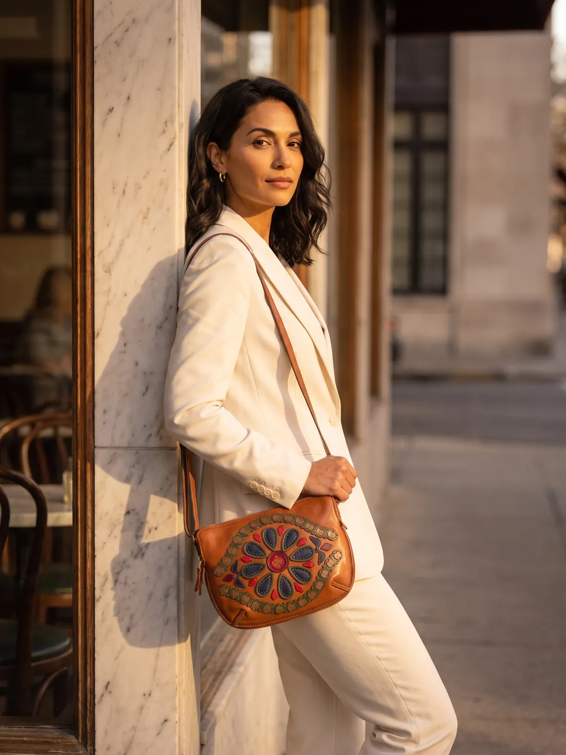 GÖN Handmade Medallion Crossbody Bag worn — carried in Tan Multi, from the campaign