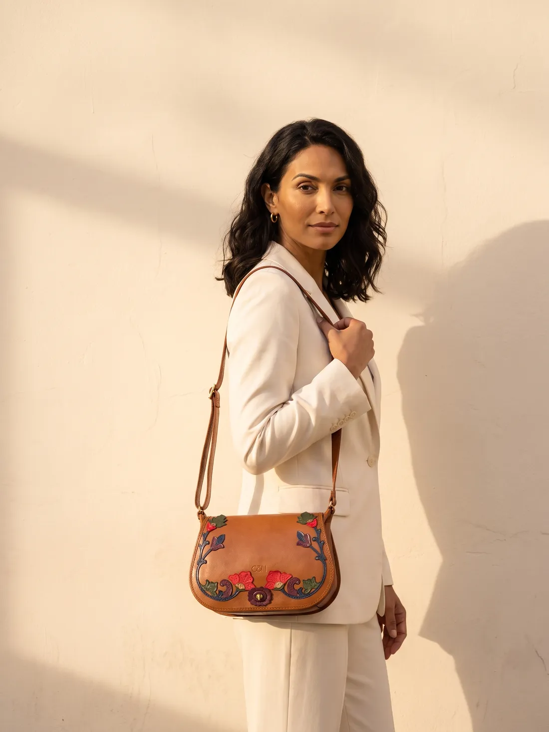 GÖN Handmade Vine Appliqué Saddle Bag worn — carried in Tan Multi, from the campaign
