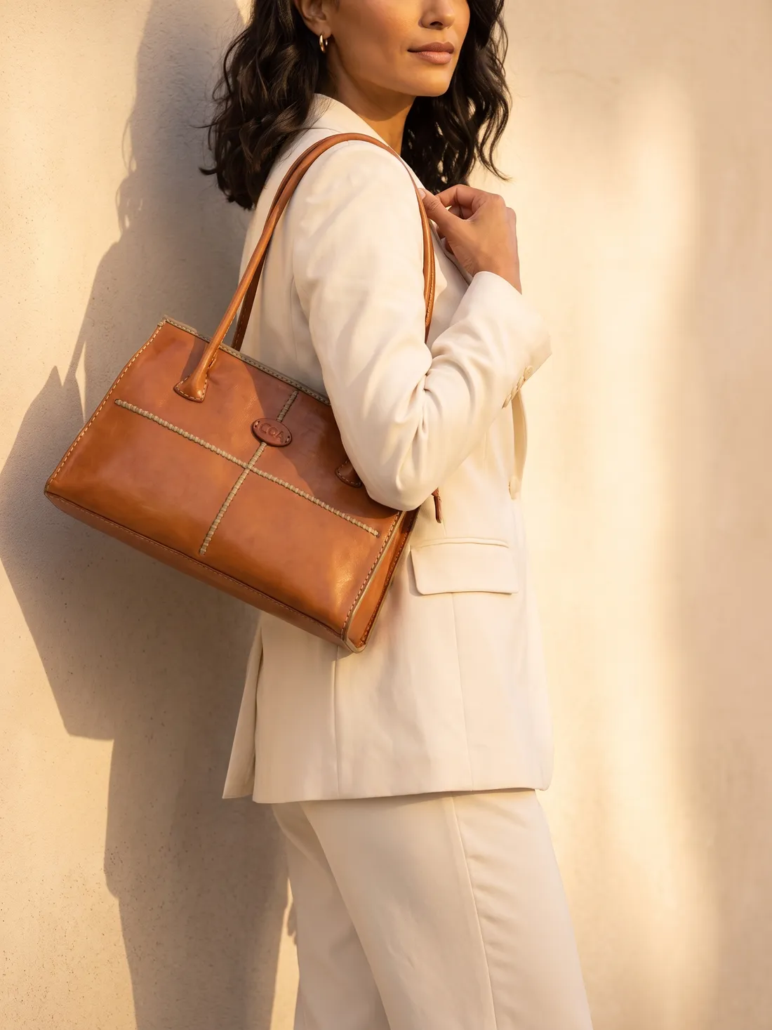 GÖN Handmade Sanra Shoulder Bag worn — carried in Tan, from the campaign