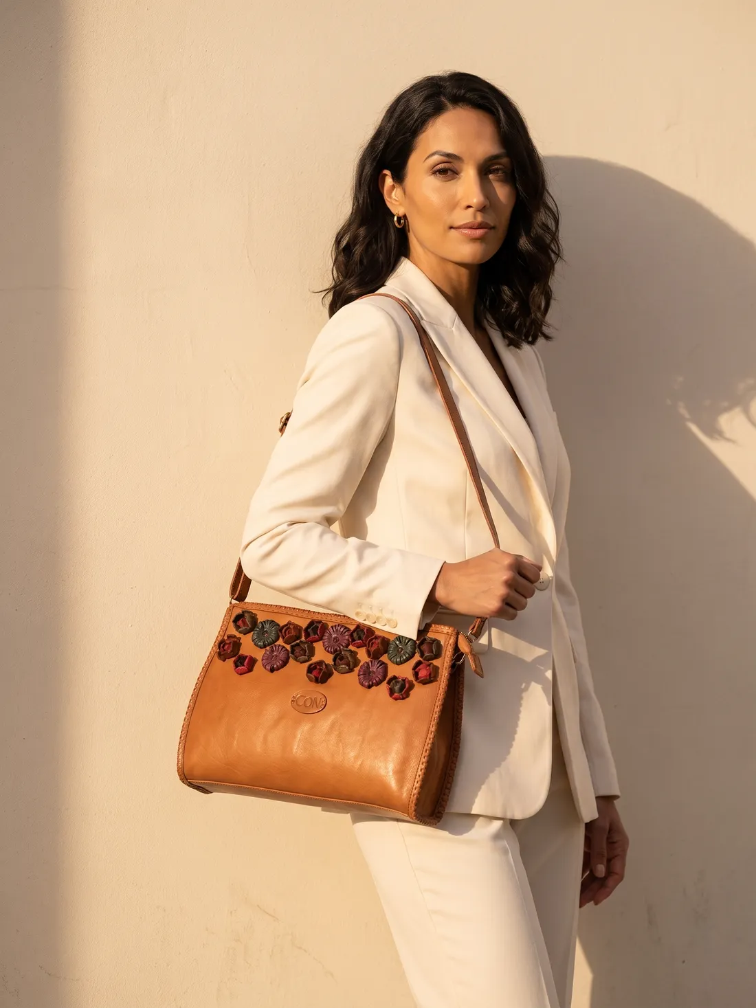 GÖN Handmade Plat Handbag worn — carried in Tan, from the campaign