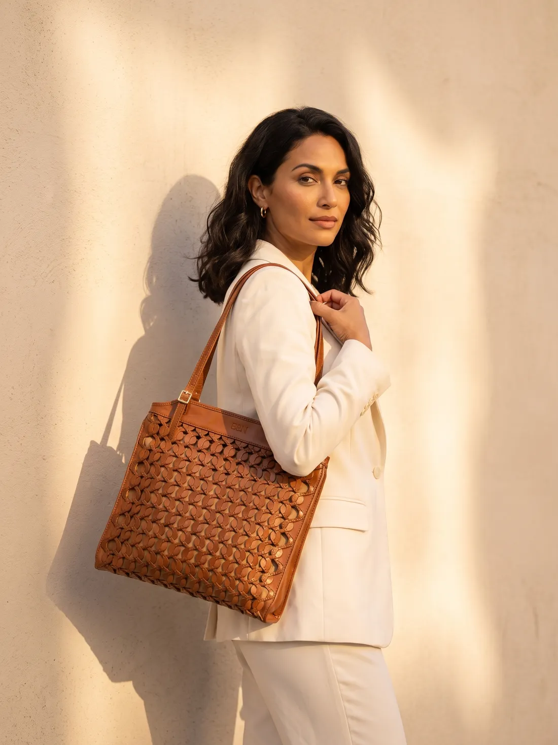 GÖN Handmade Siren Tote worn — carried in Tan, from the campaign
