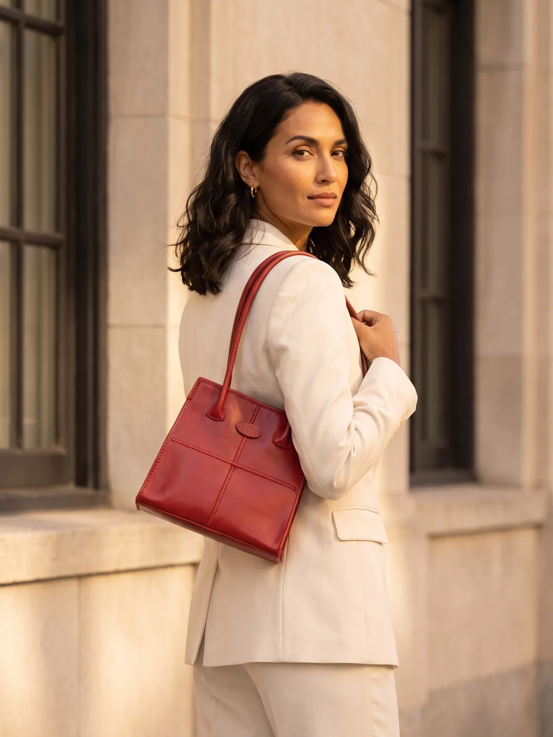 GÖN Handmade Compact Shoulder Bag worn — carried in Red, from the campaign