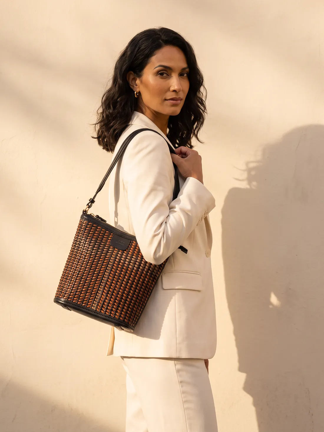 GÖN Handmade Woven Bucket Bag worn — carried in Black Multi, from the campaign