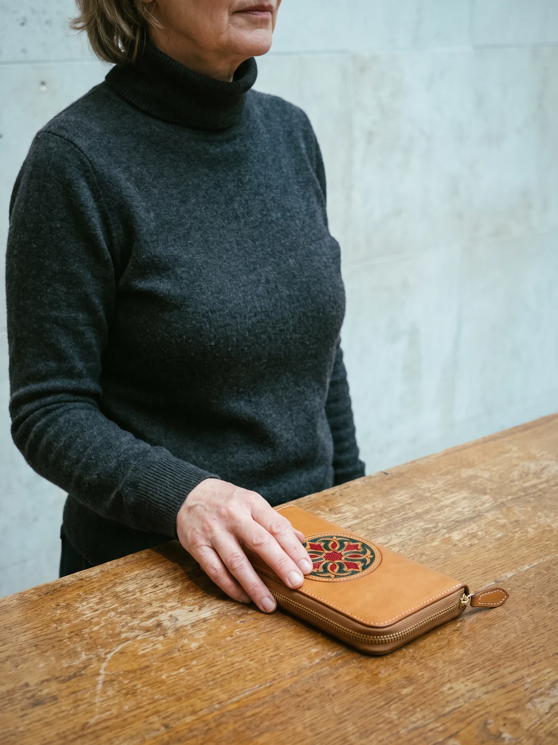 GÖN Handmade Tooled Zip Wallet worn — carried in Tan, from the campaign